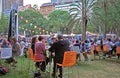 People at the tables are enjoying dining and festivities during Night Noodle Market