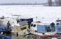 People take out trapped boat from the frozen Danube river