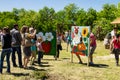 People take photo in photo board with face cutouts for family photography fun