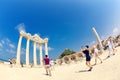 People take pictures of ancient monumental stone arch of Temple of Apollo in Side Royalty Free Stock Photo