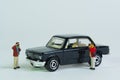 People take pictures of a black vintage car, miniature figures scene, toy car, Royalty Free Stock Photo