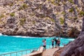 People take pictures of the landscape on phone. Beautiful famous bay of Sa Calobra on the island of Mallorca, Spain.