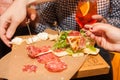 People take starters tapas from wooden plate Royalty Free Stock Photo