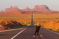 People taking photo on Forrest Gump Point at US Highway 163 toward Monument Valley Navajo Tribal Park. Royalty Free Stock Photo