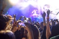 People taking photographs with touch smart phone during a music entertainment public concert, hands in the air Royalty Free Stock Photo