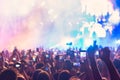 People taking photographs with touch smart phone during a music entertainment public concert