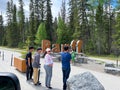 People taking the photos in front of the Banff Sign in Banff Natiaonal Park in Canada Royalty Free Stock Photo
