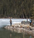 People taking pictures at Lake Louise and mountains Royalty Free Stock Photo