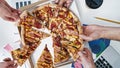 People Taking Pizza on Lunch in Creative Office. Different Hands Taking Pizza. Eating at Work Place. Fast Food Royalty Free Stock Photo