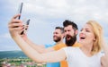 People taking selfie or streaming online video. Mobile internet and social networks. Mobile dependency problem. Girl and Royalty Free Stock Photo