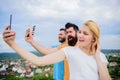 People taking selfie or streaming video. Mobile internet social networks. Mobile dependency problem. Bloggers team. Girl Royalty Free Stock Photo