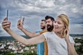 People taking selfie or streaming video. Mobile internet social networks. Mobile dependency problem. Bloggers team. Girl Royalty Free Stock Photo