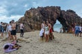 People taking a souvenir photo in front of the natural arch of Jericoacoara on Brazil