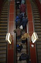 People taking subway escalator going up