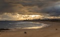 People taking a walk on Tynemouth`s Longsands beach during Lockdown on a cloudy and rainy day, in the north east of England Royalty Free Stock Photo