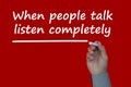 When people talk, listen completely text on red cover background.