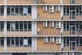 People talk on phone when standing on different floors of office building with large windows. Air conditioners on facade