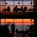 People talking at colorful sunset in restaurant