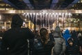 People talking photos of Bit.fall installation by Julius Popp in Canary Wharf, London, UK