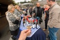 People tasting wine around table with wine bottles during festival Tbilisoba