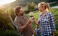 People tasting wine in vineyard