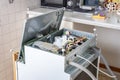 People in technician jobs. A broken built-in dishwasher in a white kitchen was removed from the kitchenette then turned upside Royalty Free Stock Photo