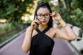 People, technologies and communication concept. Portrait of young attractive Asian business woman in trendy black wear Royalty Free Stock Photo