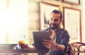 Man with tablet pc drinking beer at bar or pub Royalty Free Stock Photo