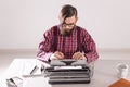 People and technology concept - Portrait of bearded man in plaid shirt typing over grey background Royalty Free Stock Photo