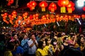 People in a temple with red lanterns on the ceiling. Emperor Jade Temple in Saigon. (Ho Chi Minh City, Vietnam - 25/01/2020