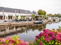 People on terrace of cafe restaurant by canal in village of Warten, Leeuwarden, Netherlands