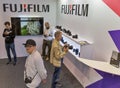 People testing professional photographic cameras on FujiFilm booth. Kyiv, Ukraine