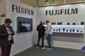 People testing professional photographic cameras on FujiFilm booth. Kyiv, Ukraine