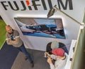 People testing professional photographic cameras on FujiFilm booth. Kyiv, Ukraine