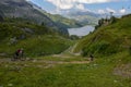 People on their mountain bikes going down the path from Jochpass Royalty Free Stock Photo