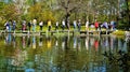 People walking over stones in water body in keukenhof garden, Lisse Netherlands