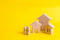 People and three houses on a yellow background. Buying and selling of real estate, construction. Apartments and apartments. City, Royalty Free Stock Photo