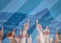 People with thumbs up against blue background with american flag Royalty Free Stock Photo