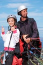 People, thumbs up and outdoor in nature for paragliding, extreme sport and portrait in sunshine. Man, woman and fitness