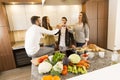 People toasting with white wine in the kitchen Royalty Free Stock Photo