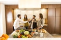 People toasting with white wine in the kitchen Royalty Free Stock Photo