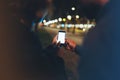 People together pointing finger on screen smartphone on background bokeh light in night atmospheric city, group adult hipsters Royalty Free Stock Photo