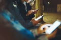 People together pointing finger on screen smartphone on background bokeh light in night atmospheric city, group adult hipsters Royalty Free Stock Photo