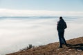 people at the top of the mountain enjoy view, look at the beautiful scenery above the clouds