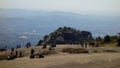 People on top of Pedra Grande, a stone hill in Atibaia, Sao Paulo, Brazil. huge rock formation of natural monument, paraglider lau