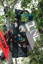 People people on the top of the tree at Extinction Rebellion Protest at Parliament square