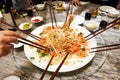 People tossing yee sang or yusheng during Chinese New Year