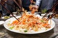 People tossing yee sang or yusheng during Chinese New Year