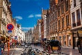People touring around the beautiful Bruges town on a carriage pulled by a horse