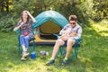 People, tourism and nature concept - Couple having fun on camping trip Royalty Free Stock Photo